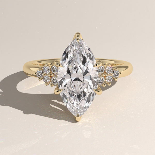 The Marquise Claw Solitaire with Clustered Round Shoulder Stones Engagement Ring